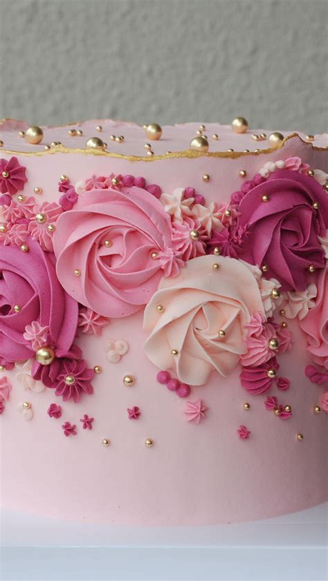 Delicate Pink and Gold Decorated Cake with Floral Accents
