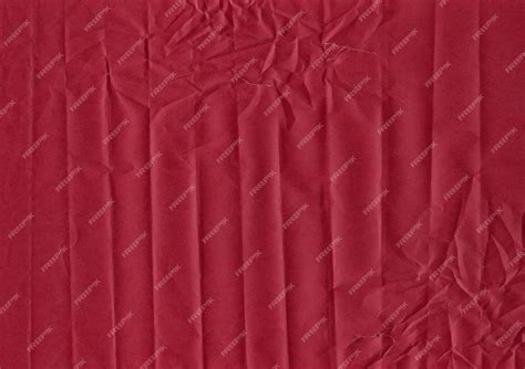 Premium Photo | Horizontal wrinkled folds on burgundy paper with tears