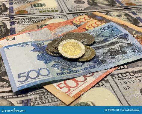 Hundreds Dollars and Kazakhstani Tenge in the Center. Dollars and Tenge ...