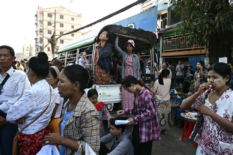 A released prisoner, right, is welcomed by her colleague after she was released from Insein Prison Sunday, Jan. 4, 2026, in Yangon, Myanmar. (AP Photo/Thein Zaw)