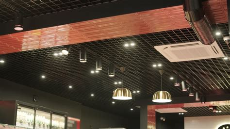 Modern ceiling featuring grid patterns, recessed lighting, pendant ...