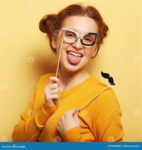 Young Woman with Fake Mustaches and Glasses Over Yellow Backgro Stock ...
