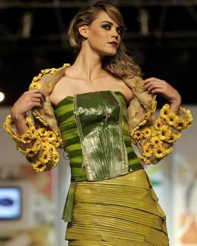 A model showcases a creation made of leaves and flowers by Colombian ...