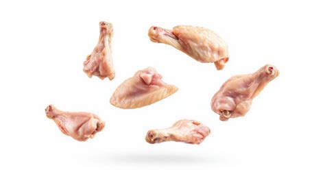 A selection of raw chicken on a white background | Premium AI-generated ...