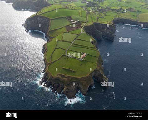 green grassland and rock land landscape of the Azores islands in the Atlantic ocean, touristic ...
