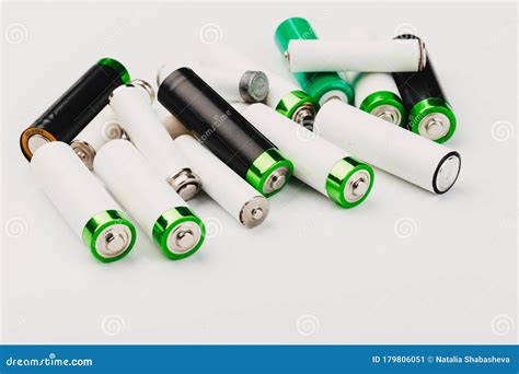Many New and Used Alkaline the Positive Ends of Battery Cells. Type AA on a Light Background ...