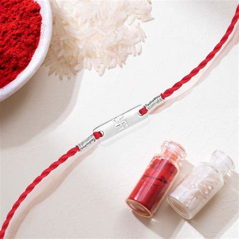 Swastik Charm Rhodium-Plated Sterling Silver Thread Rakhi For Him – Zavya