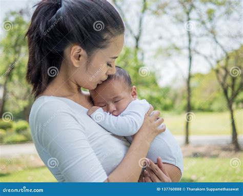 Happy Family, Pretty Woman Holding a Newborn Baby in Her Arms on Nature ...