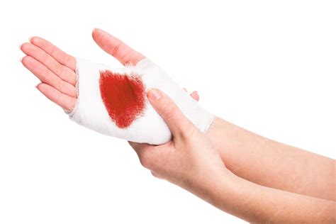 Premium Photo | White medicine bandage on injured hand with blood.