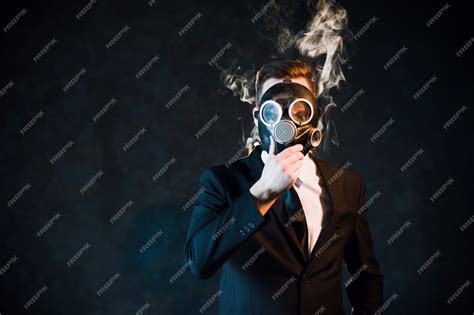 Man covering his face with a gas mask surrounded by nicotine smoke ...