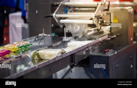 Automatic food packing machine in food industry Stock Photo - Alamy