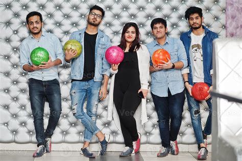 Group of five south asian peoples having rest and fun at bowling club ...