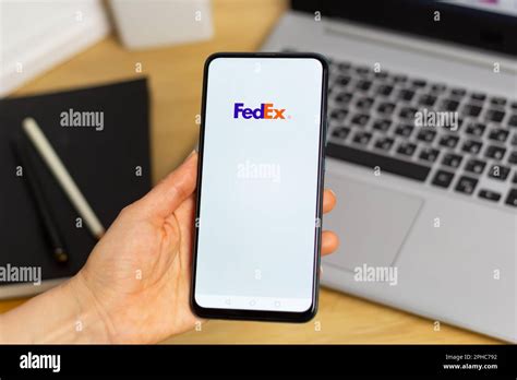 Kyiv, Ukraine - Mar. 20th, 2023: FedEx logo on phone screen, postal and ...