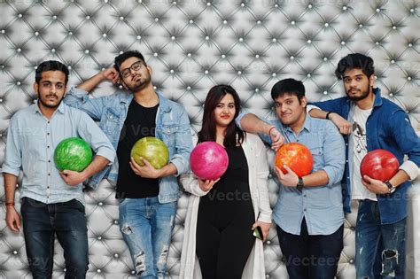 Group of five south asian peoples having rest and fun at bowling club ...