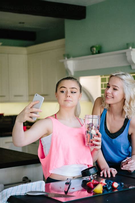 "Two Young Women Taking Selfies In A Kitchen" by Stocksy Contributor ...