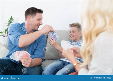 Happy Young Family Playing Card Game at Home. Stock Image - Image of ...