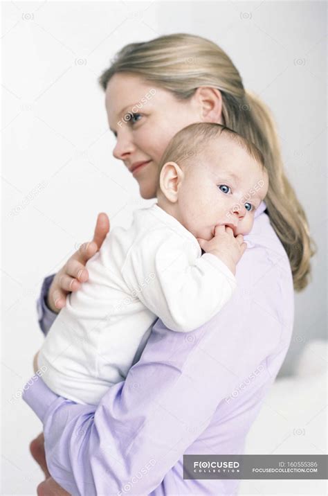 Mother holding baby daughter. — person, parent - Stock Photo | #160555386