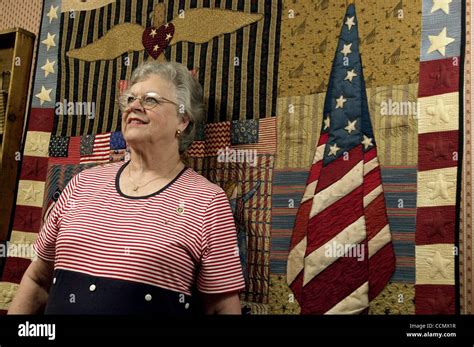 Margaret Peters poses for a photo with a quilt she made at her home in ...