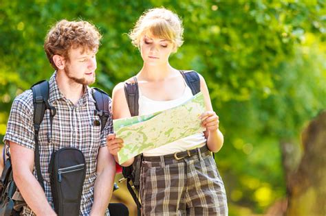 long-term couple travel planning route with maps and backpacks