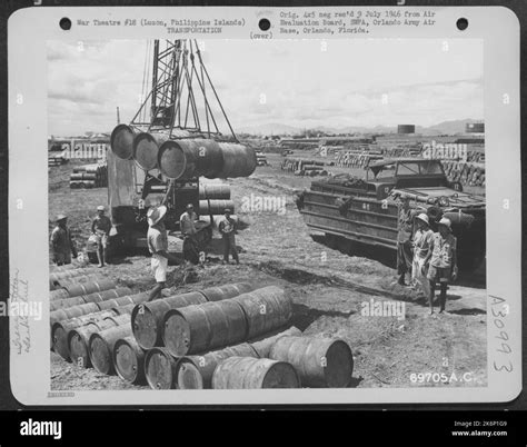 A "Buck-eye crawler" unloads six 53 gallon drums of diesel fuel from a ...