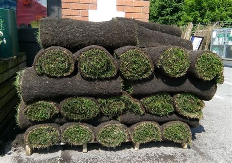 Rolls of turf sit in a pile on a sunny day - Free images & pictures