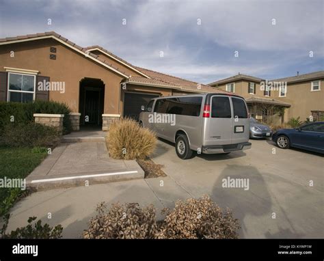 Perris, California, USA. 16th Jan, 2018. Cars sit in the driveway of ...