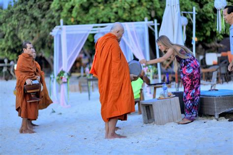 Making merit by offering food to monks on the beach on Koh Lipe