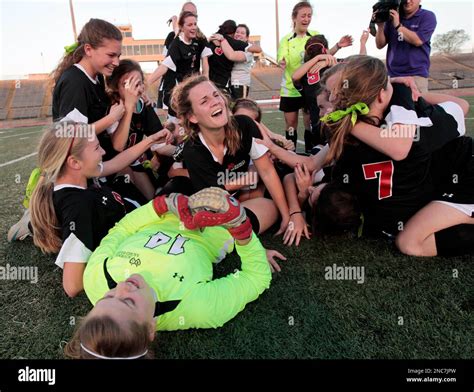 Members of the Academy of the Sacred Heart soccer team celebrate their win over Catholic High of ...