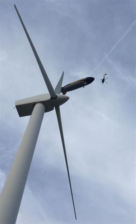 The Goodyear Blimp, flying through a wind turbine, about to crash into ...