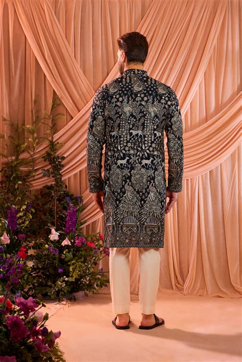 A blue royal heritage kurta adorned with detailed flora and fauna ...