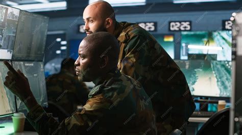 Military soldiers using radar devices to look at assault zones on ...