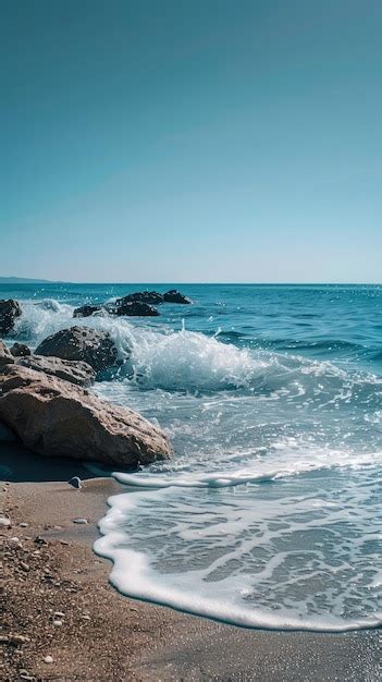 Azure sea hitting the rocks on the beach | Premium AI-generated image