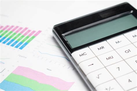Business charts green with calculator, glasses and pen | Premium Photo