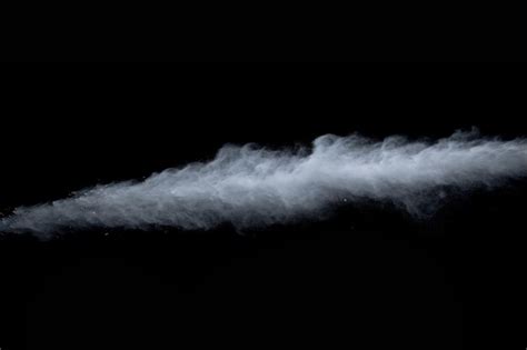 White powder explosion on black background | Premium Photo