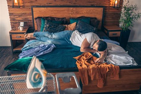Dark-haired young man in white tshirt feeling tired | Premium Photo