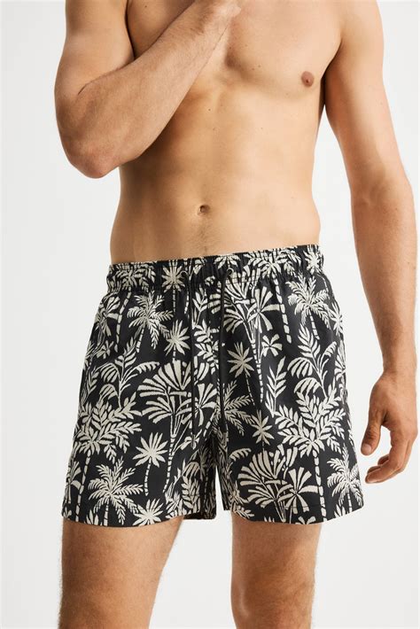 Men’s Black/Palm trees Patterned swim shorts | H&M IN