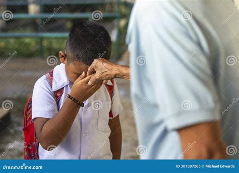 A Young School Boy Pays Respect To His Grandfather by Doing the Mano Po ...
