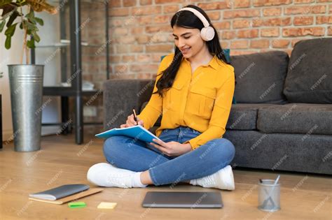 Premium Photo | Positive spanish teenager lady in headphones studying ...