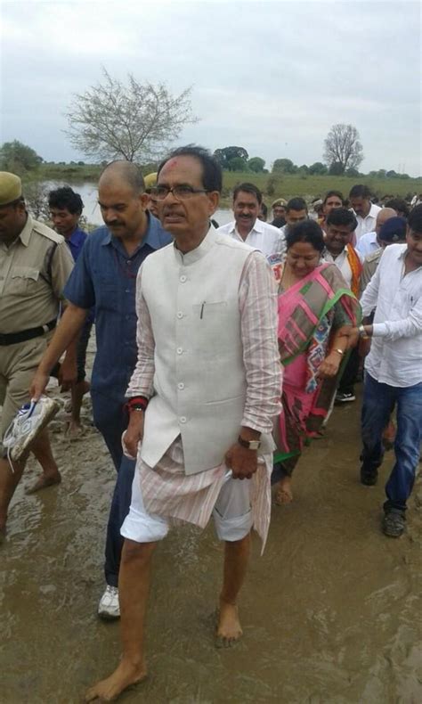Shivraj Singh Chouhan carried by cops during visit to flood-affected ...