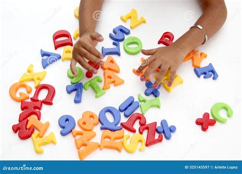 Hands of Mom and Daughter Play with the Game of Colored Letters As ...