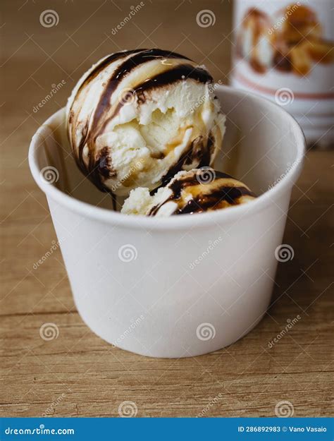 White Balls of Ice Cream with Chocolate and Caramel Topping in a Glass ...