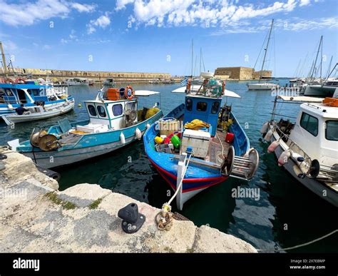 Several small fishing boats in historic Venetian harbour of Heraklion ...