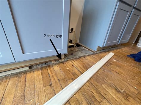 How do I fill this gap between the new cabinets and the old hardwood ...