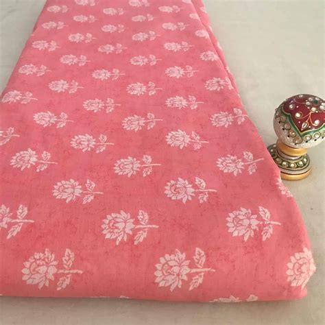 dark-peach-and-white-floral-motif-peach-viscose-muslin-fabric