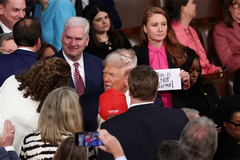 ‘This is not normal’ sign ripped away as Trump walks past | Donald ...