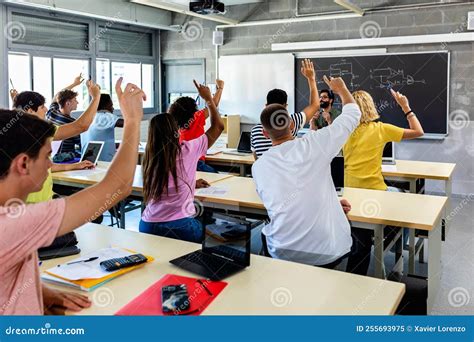 Group of High School Students Raising Hands in Classroom Stock Image ...