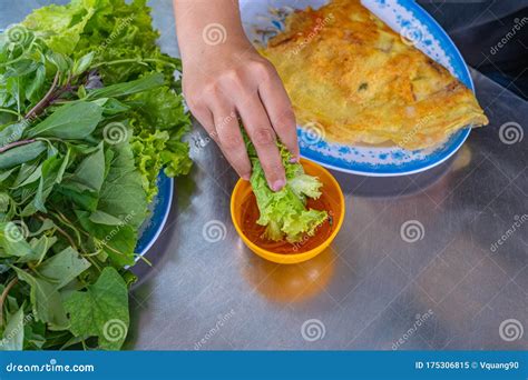People Eating Banh Xeo Crepe with Vegetable and Dipping Sauce Stock ...