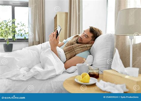 Sick Man with Smartphone in Bed at Home Stock Photo - Image of fever ...
