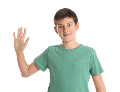 Happy teenage boy waving to say hello on white background | Premium Photo