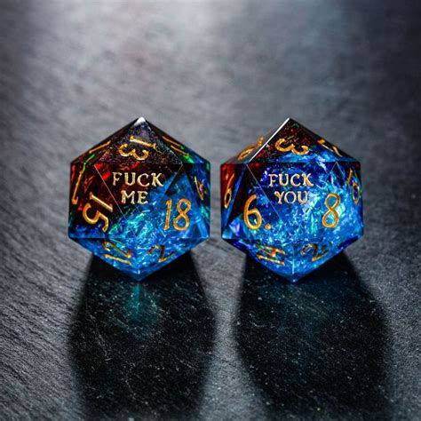 two blue dices with gold numbers on them sitting next to each other in ...